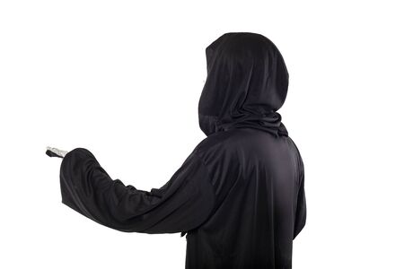 The grim reaper or death halloween costume isolated on a white background.  The skeleton is wearing a hooded black robe. Side view in profile for composites.の写真素材