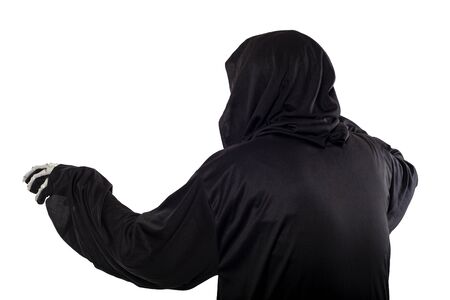 The grim reaper or death halloween costume isolated on a white background.  The skeleton is wearing a hooded black robe. Side view in profile for composites.の写真素材