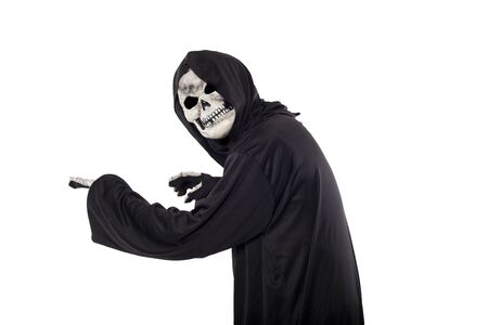 The grim reaper or death halloween costume isolated on a white background.  The skeleton is wearing a hooded black robe. Side view in profile for composites.の写真素材