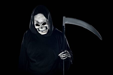 Grim Reaper ghost coming out of the shadows with a scythe or sickle.  The scary demon or monster depicts Halloween and Day of the Dead holiday.の写真素材