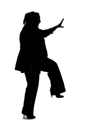 Silhouette of a curvy or plus size businesswoman on a white background for composites.  She is jumping or leapingの写真素材