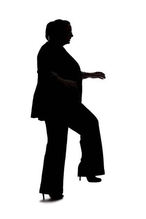 Silhouette of a curvy or plus size businesswoman on a white background for composites.  She is posed like she is falling or off balanceの写真素材