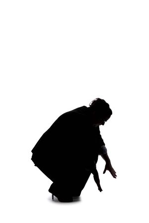 Silhouette of a curvy or plus size businesswoman on a white background for composites.  She is looking for something on the groundの写真素材