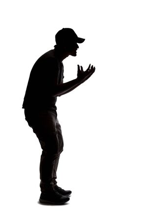 Silhouette of a man wearing casual clothes isolated on a white background. He is being rude and angryの写真素材