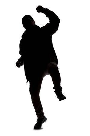 Silhouette of a male hiker or explorer isolated on a white background wearing a hat and clothes for trekking. He is gesturing as if he is happyの写真素材