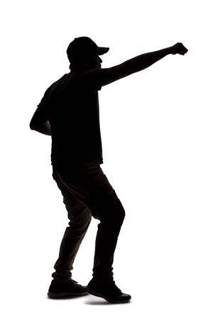 Silhouette of a man wearing casual clothes isolated on a white background. He is punching and hitting somethingの写真素材