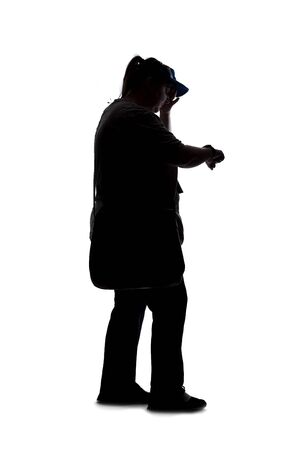 Silhouette of a curvy or plus size woman on a white background.  She is checking the time or schedule on a smartwatchの写真素材
