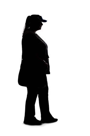 Silhouette of a curvy or plus size woman on a white background.  She is unrecognizable and standing or waitingの写真素材
