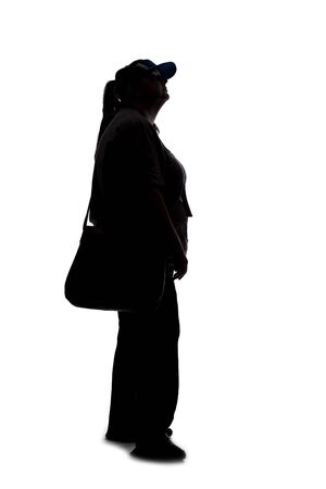 Silhouette of a curvy or plus size woman on a white background.  She is unrecognizable and is wearing casual apparel and waiting in lineの写真素材