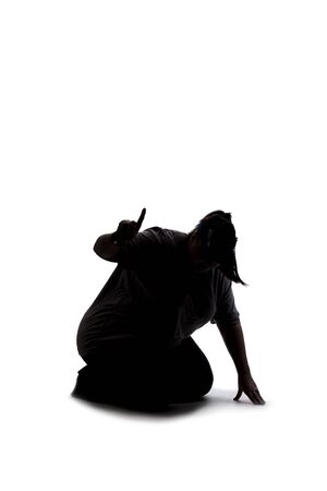 Silhouette of a curvy or plus size woman on a white background.  She is kneeling down and searching for something on the groundの写真素材