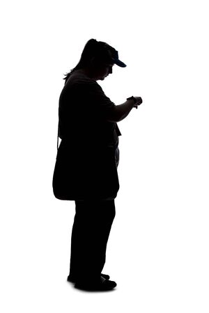 Silhouette of a curvy or plus size woman on a white background.  She is unrecognizable and is wearing casual apparel and waiting in lineの写真素材