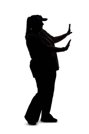 Silhouette of a curvy or plus size woman on a white background.  She is unrecognizable holding hands up as a stop gestureの写真素材