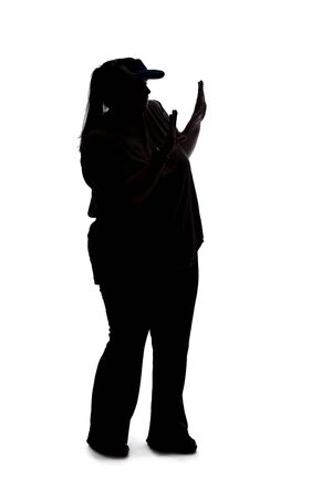 Silhouette of a curvy or plus size woman on a white background.  She is unrecognizable holding hands up as a stop gestureの写真素材