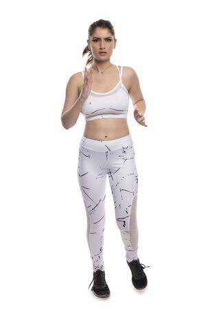 Woman wearing sports clothing running and isolated on white background for composites.  She is an active and fit Caucasian female who looks like she is exercising or practicingの写真素材