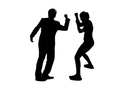Silhouette of anonymous people on a white background fighting and being rude.  They are expressing anger with violence and confronting in an aggressive mannerの写真素材