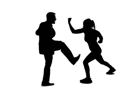 Silhouette of anonymous people on a white background fighting and being rude.  They are expressing anger with violence and confronting in an aggressive mannerの写真素材