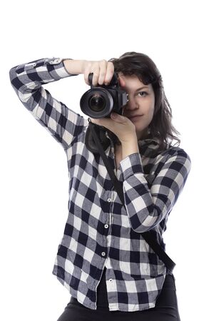 Young female art student holding a dslr camera and studying to be a professional or amateur photographer.  She looks creative and inspired to become a photo journalistの写真素材