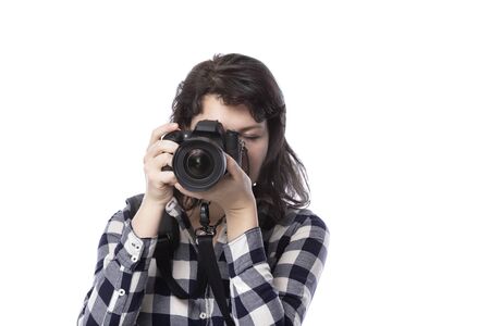 Young female art student holding a dslr camera and studying to be a professional or amateur photographer.  She looks creative and inspired to become a photo journalistの写真素材