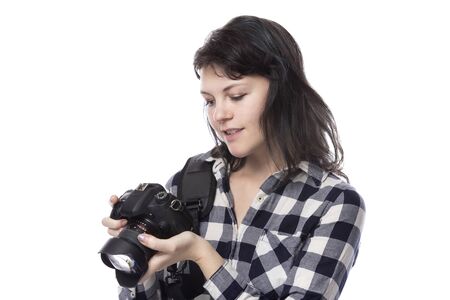 Young female art student holding a dslr camera and studying to be a professional or amateur photographer.  She looks creative and inspired to become a photo journalistの写真素材