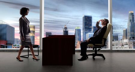 Business co workers or team having a meeting while keeping 6 feet social distancing for coronavirus or pandemic prevention.  Depicts the new normal of work while keeping the economy goingの写真素材