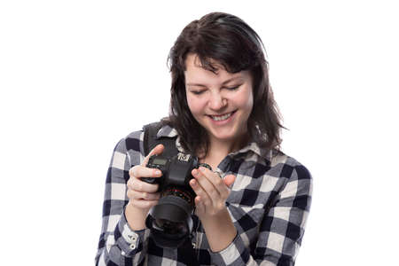 Young female freelance professional photographer or art student or photojournalist on a white...