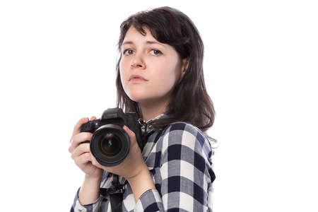 Young female freelance professional photographer or art student or photojournalist on a white background holding a camera with thumbs downの写真素材