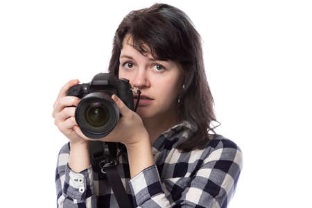 Young female freelance professional photographer or art student or photojournalist on a white background holding a camera with thumbs downの写真素材