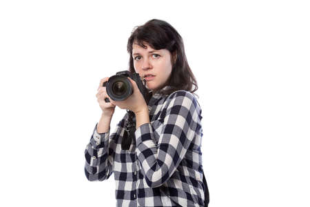 Young female freelance professional photographer or art student or photojournalist on a white...