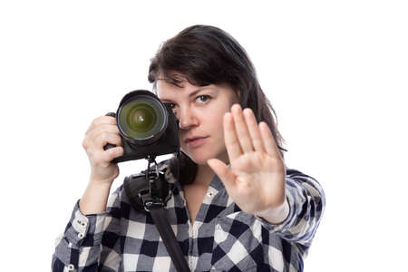 Young female freelance professional photographer or art student or photojournalist on a white...