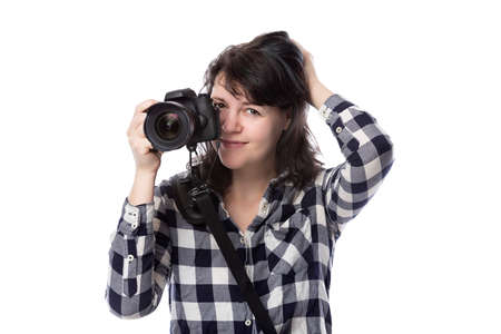 Young female freelance professional photographer or art student or photojournalist on a white background holding a camera. She is feeling sick or unwellの写真素材