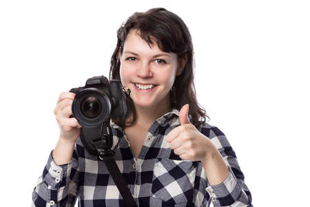 Young female freelance professional photographer or art student or photojournalist on a white background holding a camera. She is feeling sick or unwellの写真素材