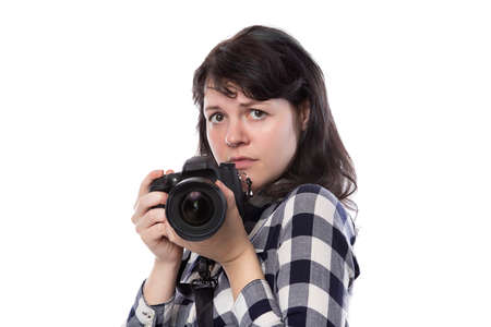 Young female freelance professional photographer or art student or photojournalist on a white background holding a camera. She is feeling sick or unwellの写真素材