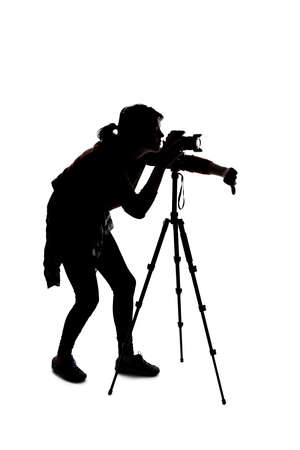 Silhouette of a photographer with a camera on a white background isolated for composites. She is posed with a thumbs down gestureの写真素材