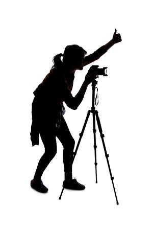 Silhouette of a photographer with a camera on a white background isolated for composites. She is posed with a thumbs up gestureの写真素材