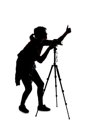 Silhouette of a photographer with a camera on a white background isolated for composites. She is posed with a thumbs up gestureの写真素材