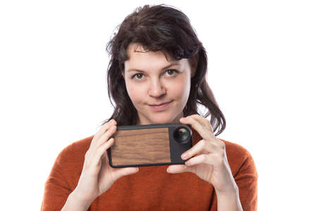 Female tourist or photographer doing mobile photography with a cell phone as an alternative equipment for hobby.  The camera phone is smaller and lighter than a traditional dslrの写真素材