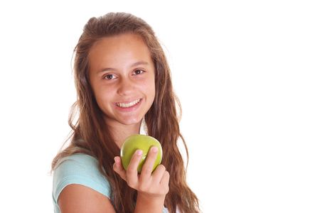 smilling teen girl with apple isolated on whiteの写真素材