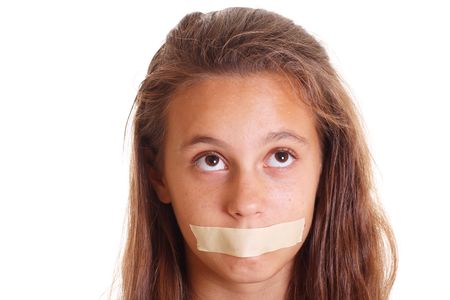 teen girl with mouth taped isolated on whiteの写真素材