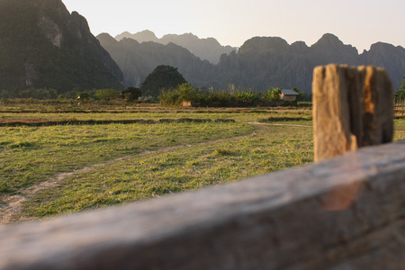 Mountain view blinded by brown fence