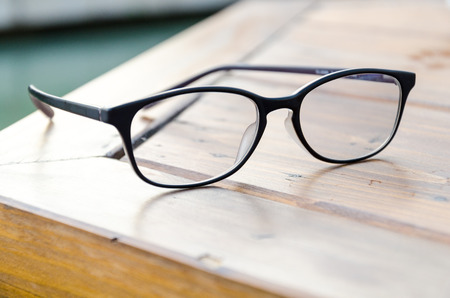 Black eye glasses on the tableの写真素材