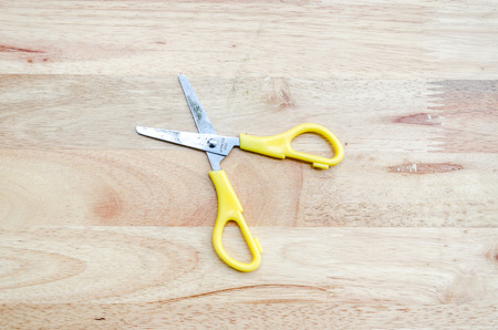 Scissors on the Wooden Backgroundの写真素材