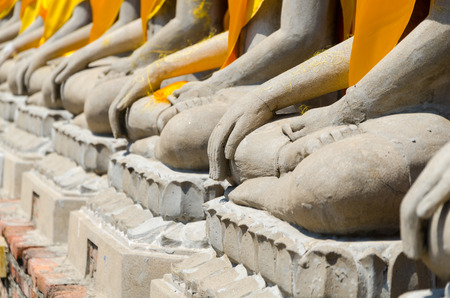 Hand of Aligned Sitting Buddha Statues at Wat Yai Chaimongkol in  Ayutthaya, Thailandの写真素材