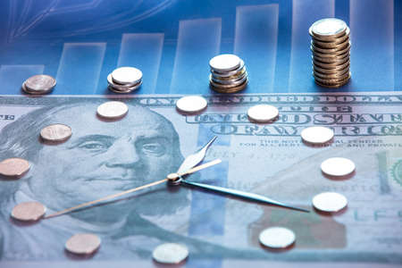 Time is money. The clock is made of coins on the background of dolor. The diagram of financial growth The concept of the financial system.の写真素材