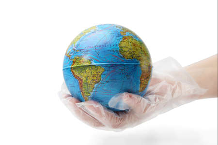 The human hand in plastic glove holds the planet earth. Isolated white background.