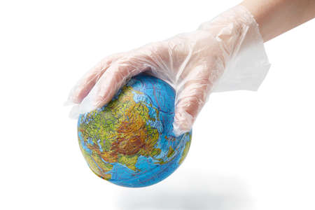 The human hand in plastic glove holds the planet earth.Isolated white background.