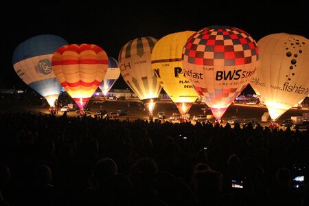 BRISTOL, ENGLAND - AUGUST 9, 2018 - Nightglow, International Balloon Festival.  Annual hot air balloon festival nightglow where the tethered balloons' firing is choreographed to music.のeditorial素材