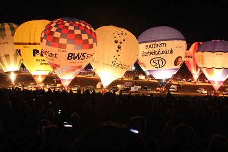 BRISTOL, ENGLAND - AUGUST 9, 2018 - Nightglow, International Balloon Festival.  Annual hot air balloon festival nightglow where the tethered balloons' firing is choreographed to music.のeditorial素材