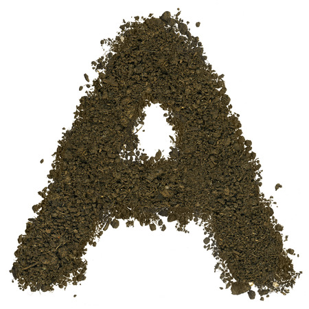 Alphabet made of brown soil on white background. High sharp and detail. Letter Aの写真素材