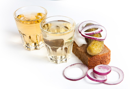 Russian vodka in small glass with black bread, pickled, onion and bit of lard on white backgroundの写真素材