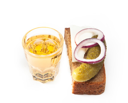 Russian vodka in small glass with black bread, pickled, onion and bit of lard on white backgroundの写真素材